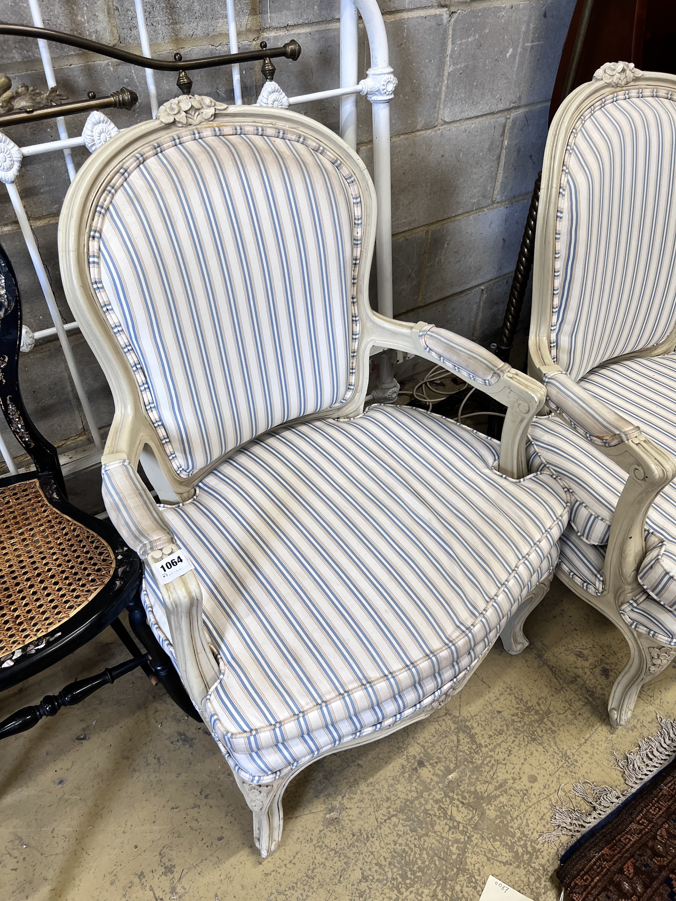 Two pairs of cream painted Louis XVI style fauteuil, heights 95cm and 91cm